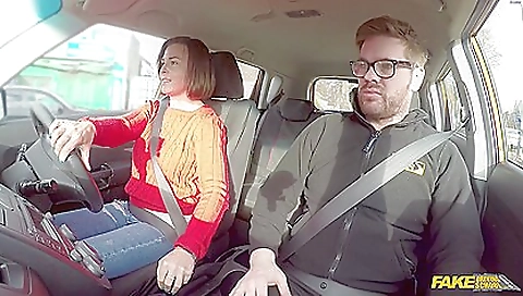 Brunette driver plays with her big tits as she drives