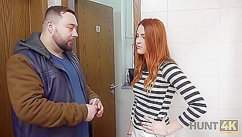 Redheaded babe in sexy red dress and black stockings