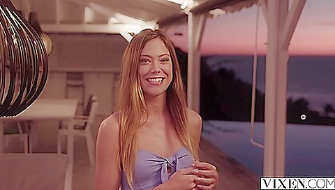 Blonde in a beach uniform is standing on the beach 038a